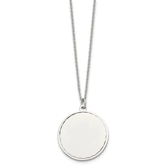 A silver-toned circular pendant with a polished blank disc hangs from a delicate chain against a white background.