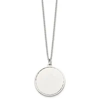 A silver-toned circular pendant with a polished blank disc hangs from a delicate chain against a white background.