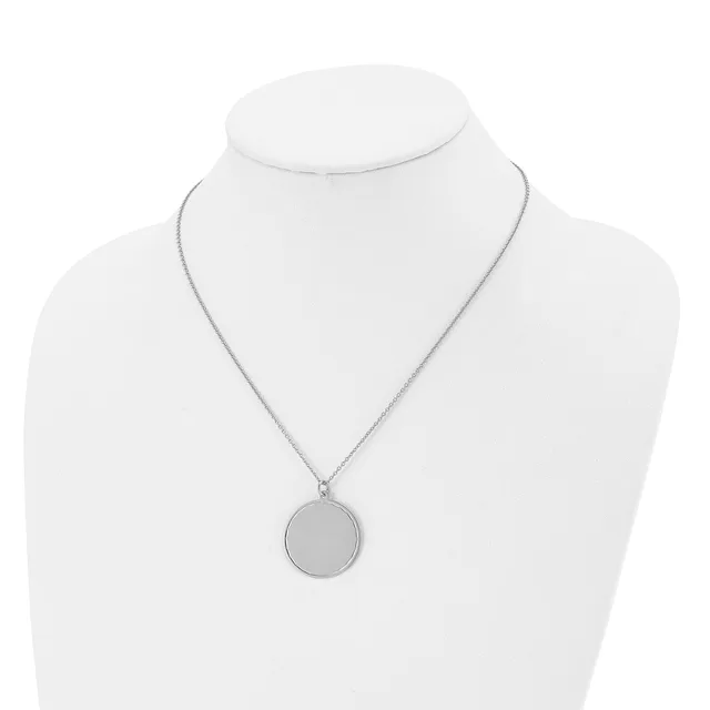 A silver-toned circular pendant necklace displayed on a white bust form mannequin.
