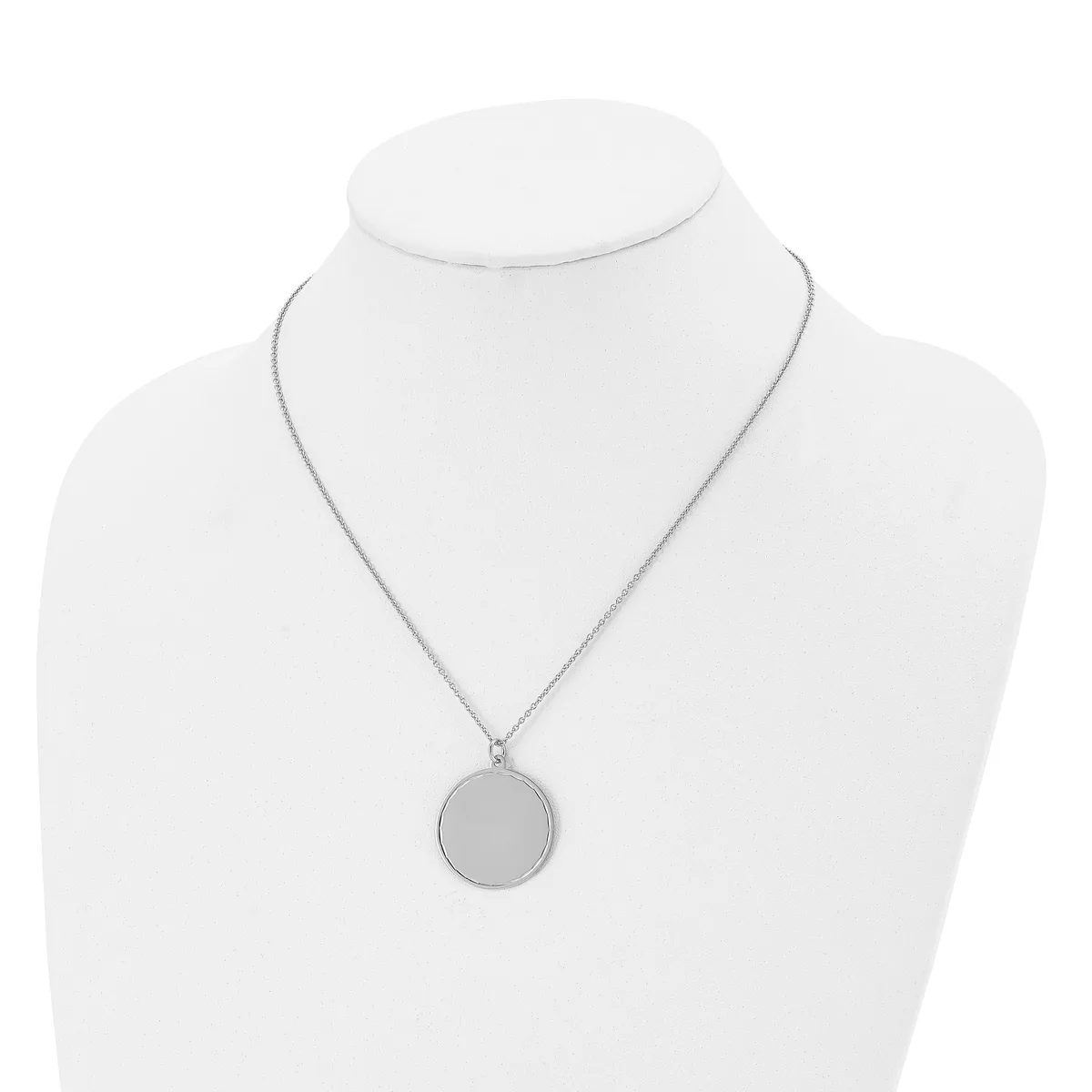 A silver-toned circular pendant necklace displayed on a white bust form mannequin.