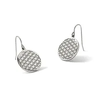 A pair of silver drop earrings with circular pendants featuring a geometric flower-of-life pattern, suspended from curved ear wires.