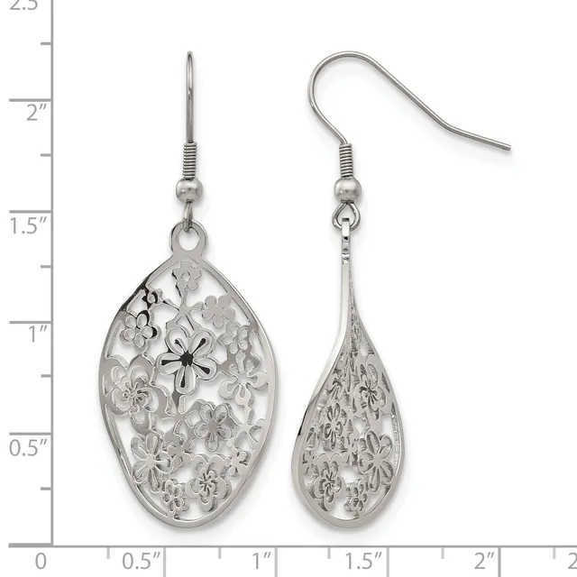 Two silver filigree teardrop earrings with floral cutout patterns, displayed on a measurement scale showing they are approximately one inch long.