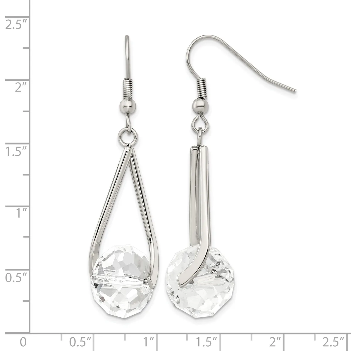 A pair of silver-toned dangle earrings with teardrop-shaped clear crystal stones, displayed against a ruler showing measurements up to 2.5 inches.
