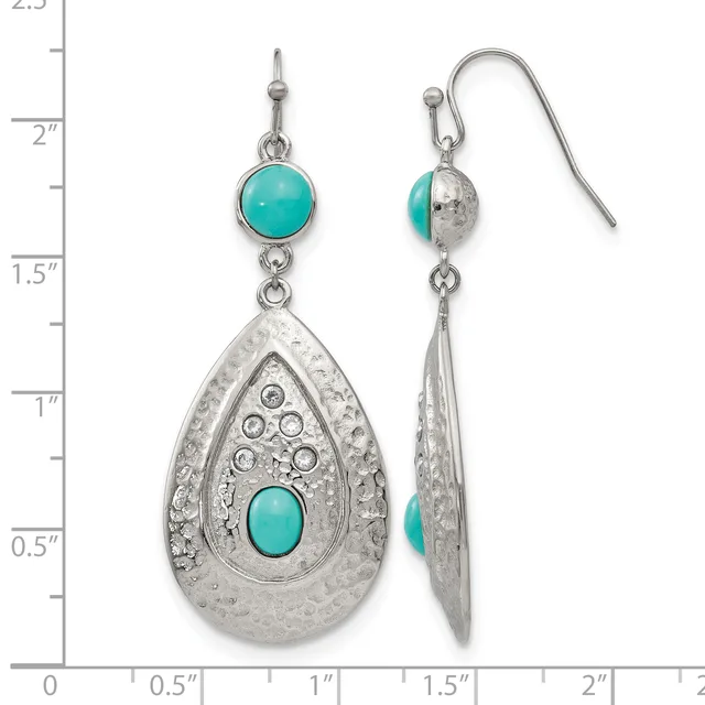 A pair of silver teardrop earrings with turquoise cabochon stones, featuring ornate filigree details and shown next to a measurement scale.