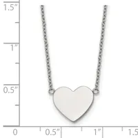 A polished silver heart pendant hangs from two delicate chains against a measurement scale showing the pendant is approximately one inch wide.