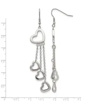 Silver-toned dangle earrings with heart charms suspended from chains, displayed on a measurement scale showing approximately three inches in length.