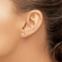 A person wearing a small square stud earring in their earlobe, shown in profile view from the side of their face and neck.