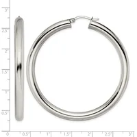 A pair of polished silver hoop earrings with a measurement scale showing their size is approximately 2.5 inches in diameter.
