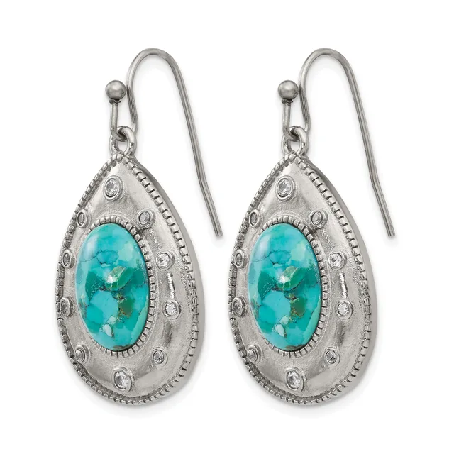 A pair of silver teardrop earrings with turquoise cabochon centers surrounded by decorative circular studs and beaded borders, hanging from shepherd's hook wires.