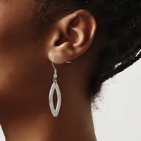A person wearing a silver elongated oval drop earring with an open center, shown from the side profile against a neutral background.