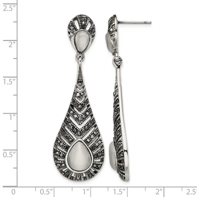 Pair of ornate silver teardrop dangle earrings with mother-of-pearl stone centers and detailed geometric patterning, shown front and side view against a measurement scale.