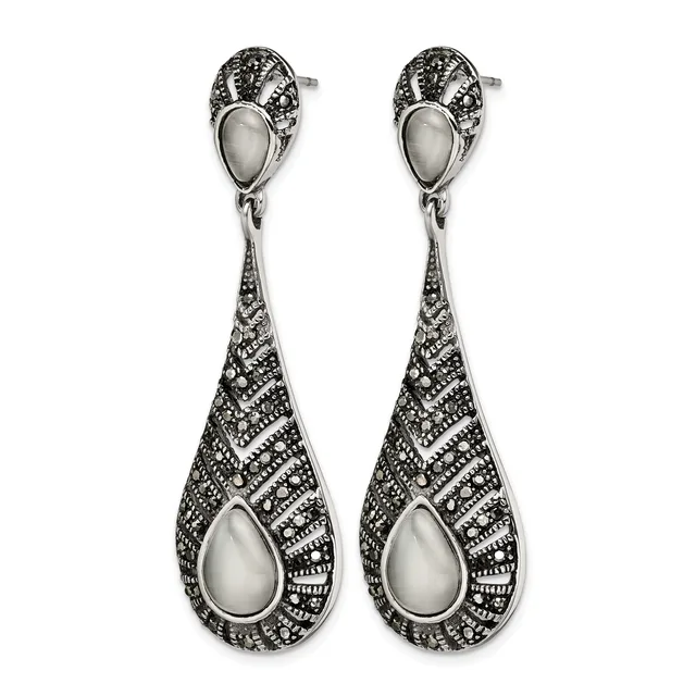 A pair of silver teardrop earrings with pearl centers and ornate filigree detailing throughout, shown against a white background.