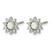 A pair of stud earrings with cream-colored pearl centers surrounded by a halo of round white diamonds set in white metal, shown against a white background.