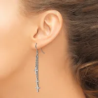 A person wearing a long dangling earring with small cross charms attached to a silver chain on a fish hook ear wire.