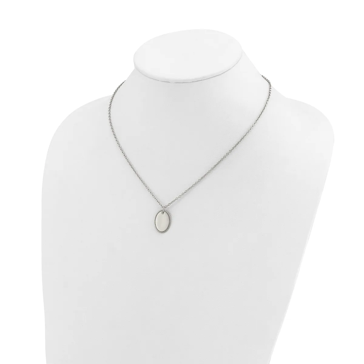 A silver-toned chain necklace with a small oval pendant featuring a pale stone or mother-of-pearl center, displayed on a white mannequin bust.