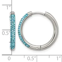 A pair of silver-tone hoop earrings with turquoise crystals embedded along the outer surface, shown with a measurement scale indicating approximately one inch in length.