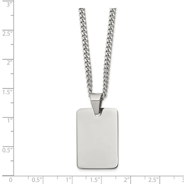A stainless steel rectangular pendant hangs from a curb chain, displayed against a measurement scale showing the pendant is approximately one inch tall.