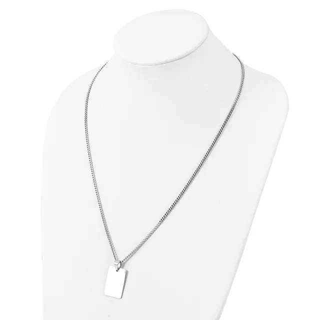 A silver-toned chain necklace with a small rectangular pendant displayed on a white mannequin bust.