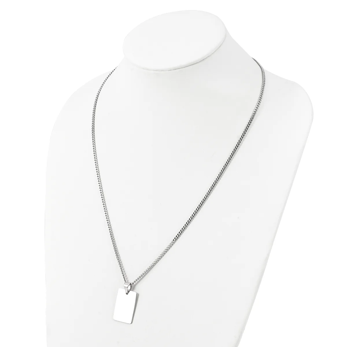 A silver-toned chain necklace with a small rectangular pendant displayed on a white mannequin bust.