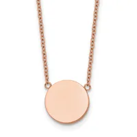 A rose gold necklace with a delicate chain suspending a polished circular disc pendant.