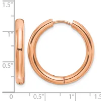 A pair of polished rose gold hoop earrings with a hinged clasp, shown next to a measurement scale indicating they are approximately one inch in diameter.
