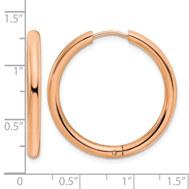 A pair of rose gold hoop earrings with a polished finish, shown next to a measurement scale indicating they are approximately one inch in diameter.