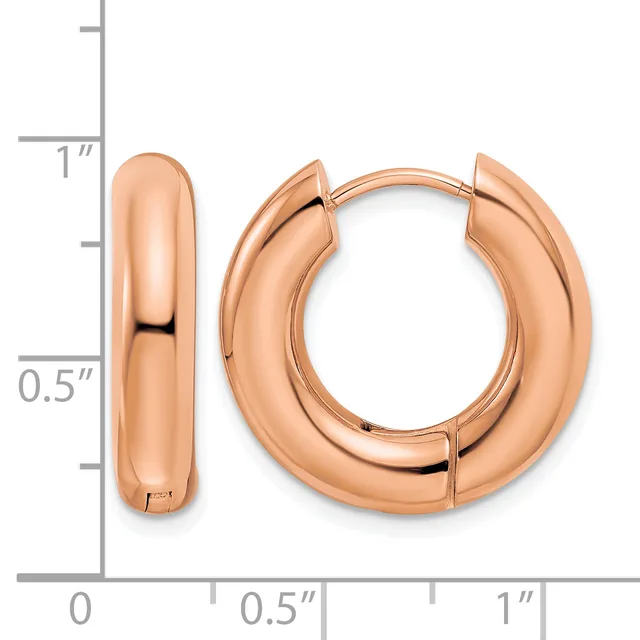 A pair of polished rose gold hoop earrings with a chunky rounded profile, displayed next to a measurement scale showing approximately one inch in height.