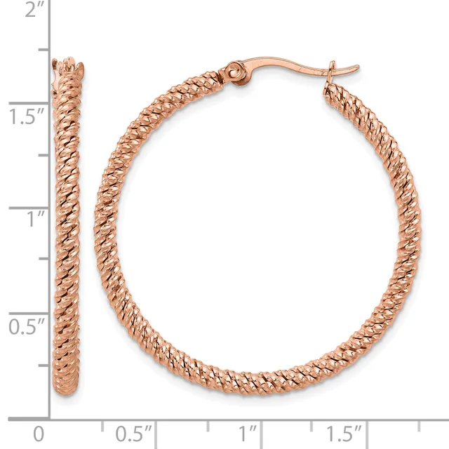 Rose gold textured hoop earrings with a twisted rope pattern, displayed on a measurement scale showing approximately 1.5 inches in diameter.
