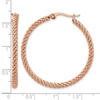 Rose gold textured hoop earrings with a twisted rope pattern, displayed on a measurement scale showing approximately 1.5 inches in diameter.