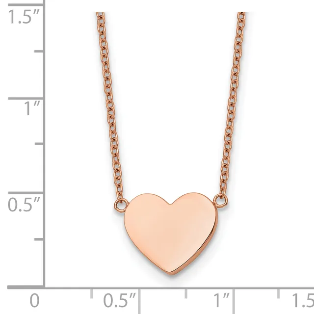 Rose gold heart pendant on a rose gold chain necklace, shown against a ruler measuring approximately 1.5 inches in length.
