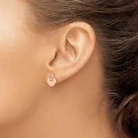 A person wearing a small silver hoop earring with a rectangular clasp detail, shown from the side profile of their ear.