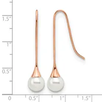 Two rose gold earrings with white pearl drops, shown next to a ruler indicating approximately 1.5 inches in length.