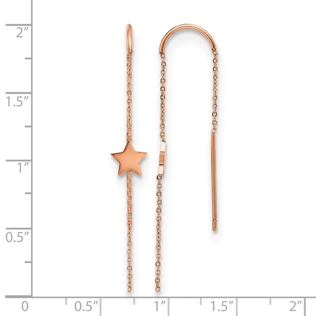Two rose gold threader earrings displayed against a ruler showing they measure approximately two inches long, one with a star charm and one plain.