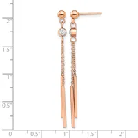 Rose gold drop earrings with ball studs, chain segments, cubic zirconia stones, and tapered tube dangles, displayed against a measurement ruler.