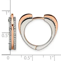 Two-tone heart-shaped hoop earrings with rose gold outer curves, white metal inner surface, and diamond pavé detailing along the sides, shown with measurement scale.