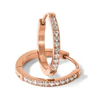 Three rose gold hoop earrings displayed together, two with diamond pavé settings and one plain polished band.