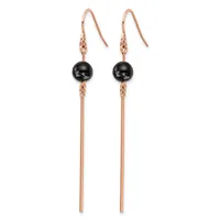 A pair of rose gold-colored drop earrings with black spherical beads suspended above long cylindrical bars, attached to matching rose gold ear wires.