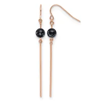 Pair of rose gold dangle earrings with black spherical stones and long thin metal rods, displayed against a white background.