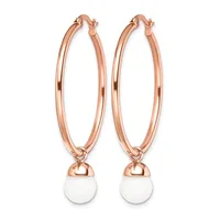 Pair of rose gold hoop earrings with white round stone or pearl charms hanging from the bottom.