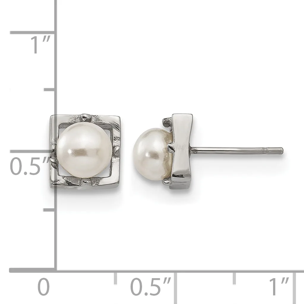 A pair of silver stud earrings with square bezels containing white pearls, shown next to a ruler indicating approximately half-inch dimensions.