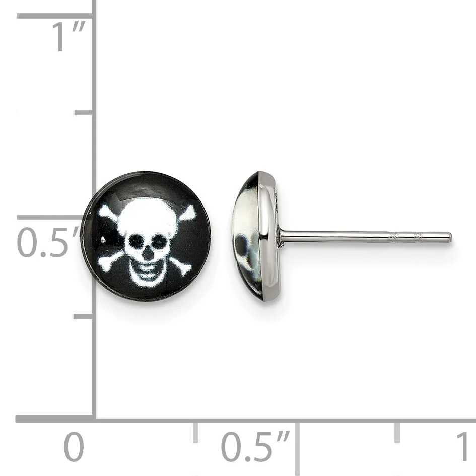 A pair of stainless steel stud earrings with black domed fronts featuring white skull and crossbones designs, shown front and side view against a ruler for scale.