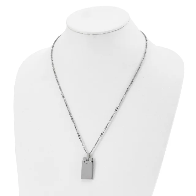 A silver-toned metal necklace with a delicate chain and a rectangular pendant displayed on a white mannequin bust.