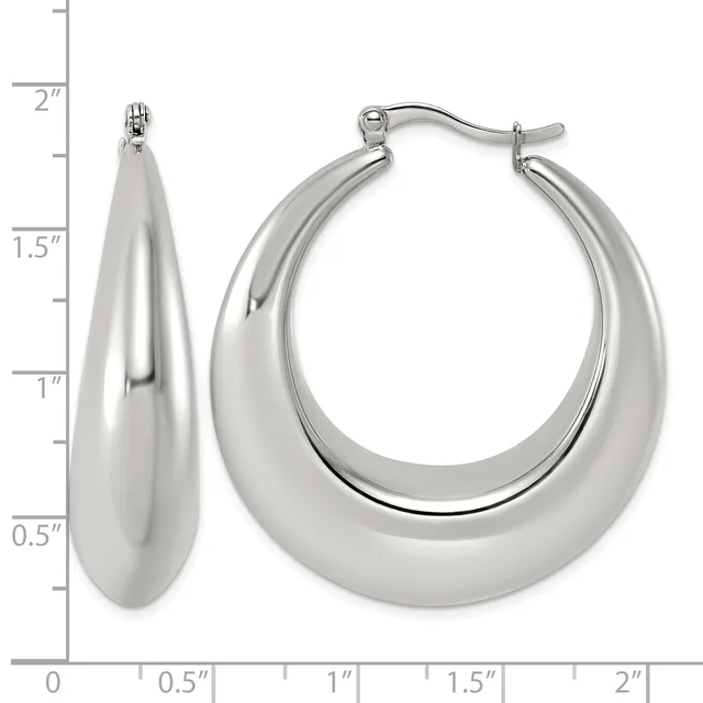 A pair of polished silver-toned chunky hoop earrings displayed next to a measurement scale showing they are approximately two inches long.