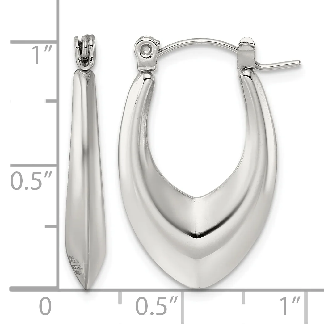 Polished silver-toned oval hoop earrings with a tapered design, displayed against a measurement scale showing approximately one inch in length.