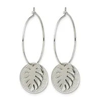 Pair of silver hoop earrings with oval loops and circular pendants featuring leaf cutout designs and textured surfaces.