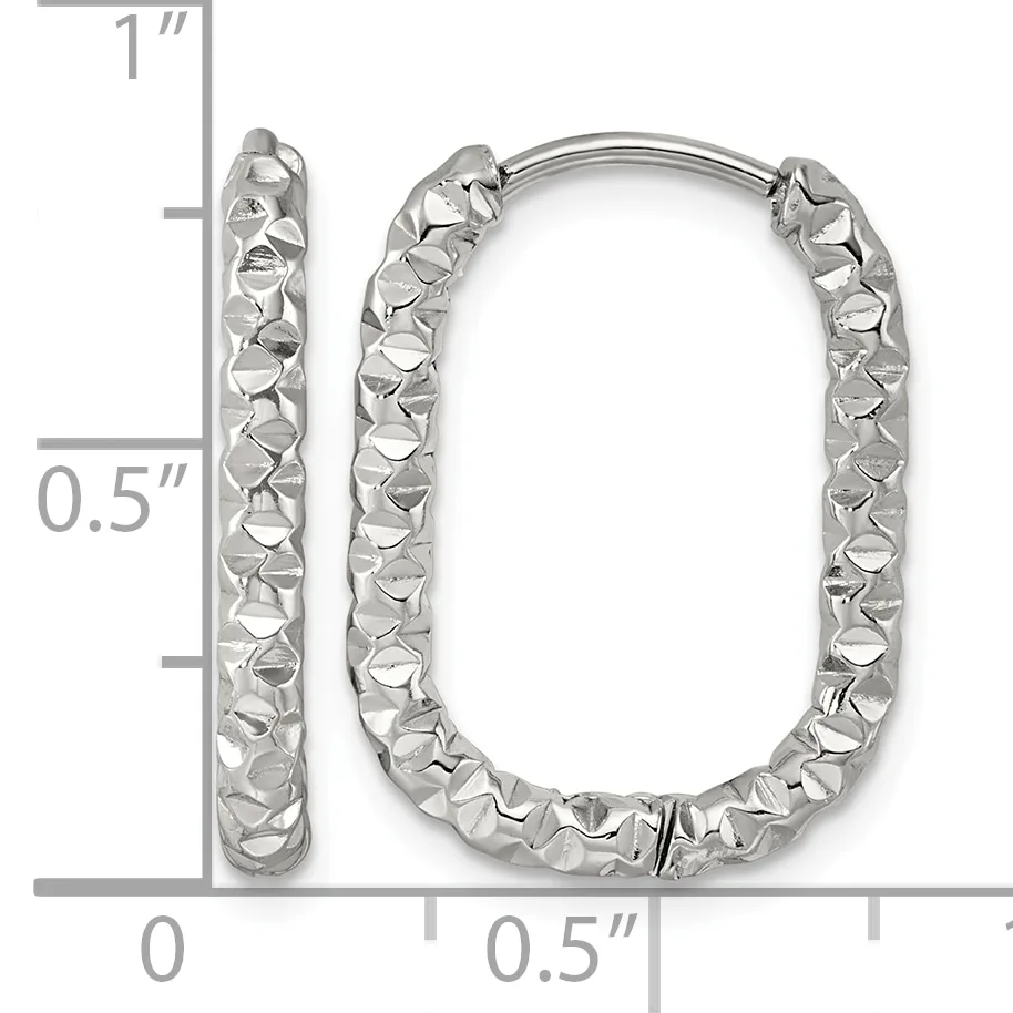 A pair of silver rectangular hoop earrings with a textured, hammered surface finish, shown next to a measurement scale indicating approximately one inch in height.