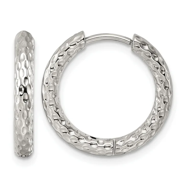 A pair of silver hoop earrings with a textured, dimpled surface pattern shown from front and side views.