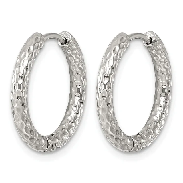 A pair of silver hoop earrings with a textured, hammered surface and hinged closures.