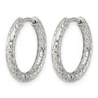 A pair of silver hoop earrings with a textured, hammered surface and hinged closures.