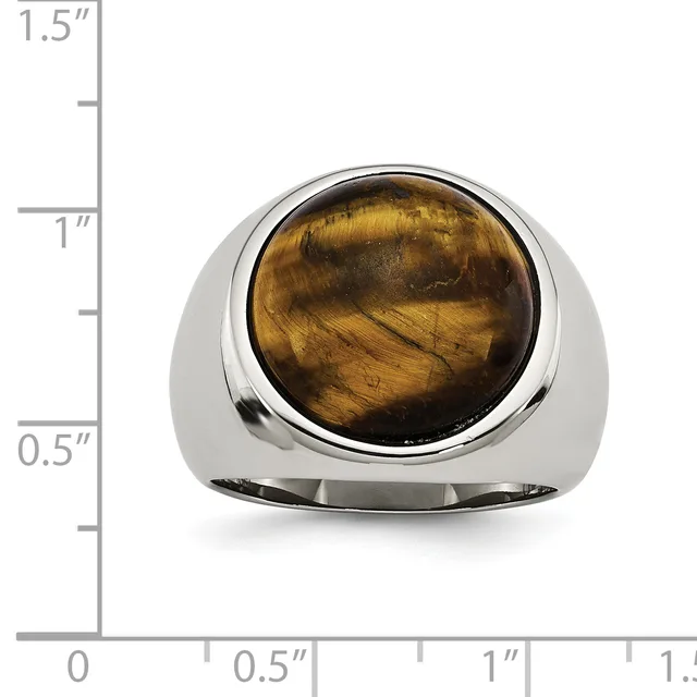 A polished silver ring with a large rounded tiger's eye cabochon stone set on top, displayed against a measurement scale showing approximately 1.5 inches in height.